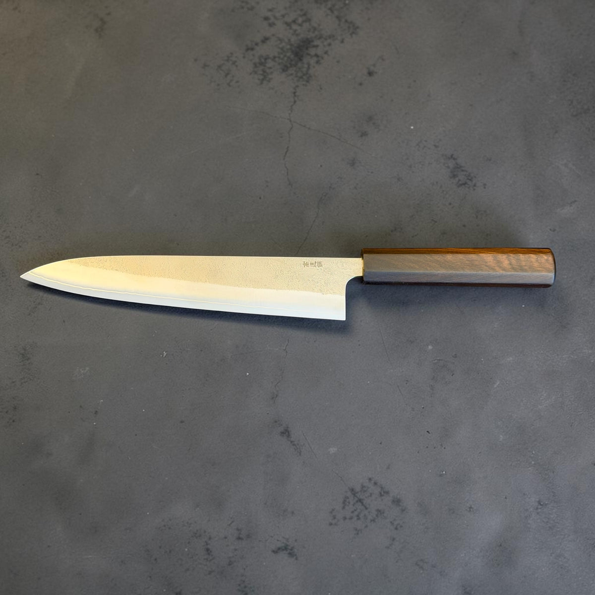 Yoshikane SKD Nashiji Gyuto 240mm with mono ebony octagonal wa handle, full maker-side view.