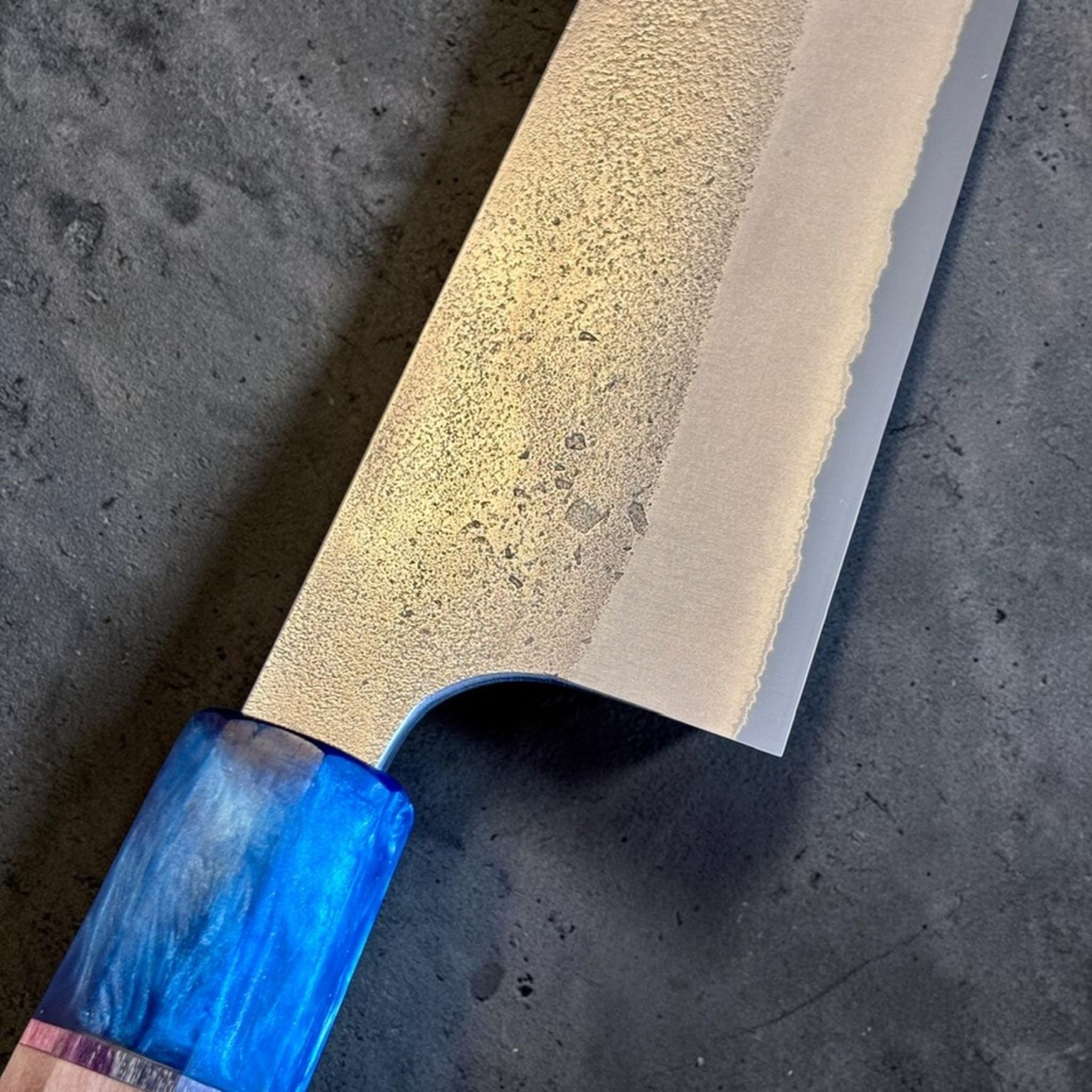 Yoshikane White #2 Nashiji Gyuto 240 mm with Prisma Blue Mountain handle, close-up of the nashiji blade texture near the heel and blue handle ferrule.