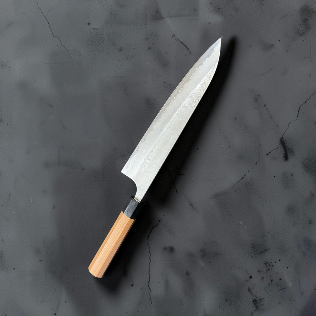 Yoshimi Kato Aogami Super Nashiji 240mm gyuto, angled reverse view showing stainless cladding and the exposed carbon steel edge.