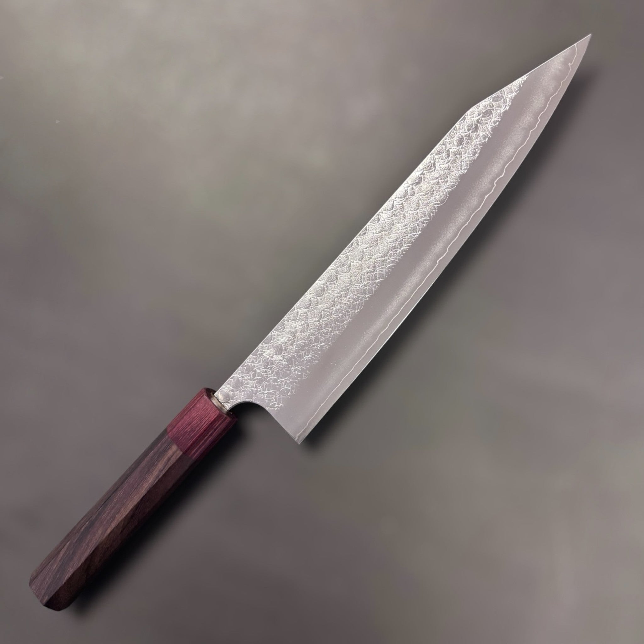 Yoshimi Kato Minamo SG2 Kiritsuke 240 mm, hero angle of the blade face showing the Minamo pattern and crisp kiritsuke tip.