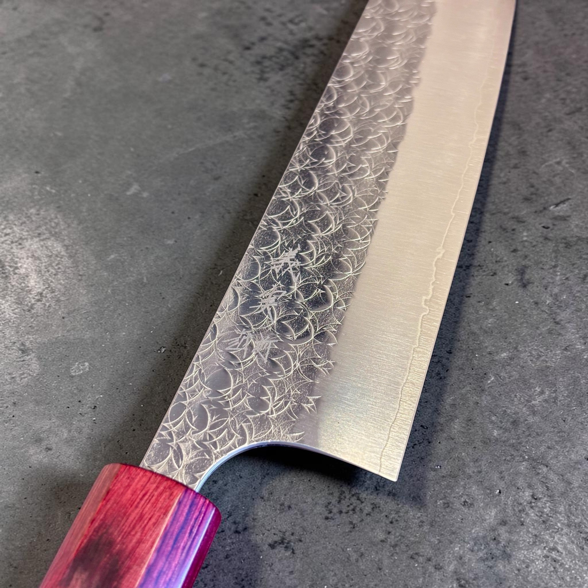 Yoshimi Kato Minamo SG2 Gyuto 210 mm, close-up of the Minamo hammered pattern near the heel.