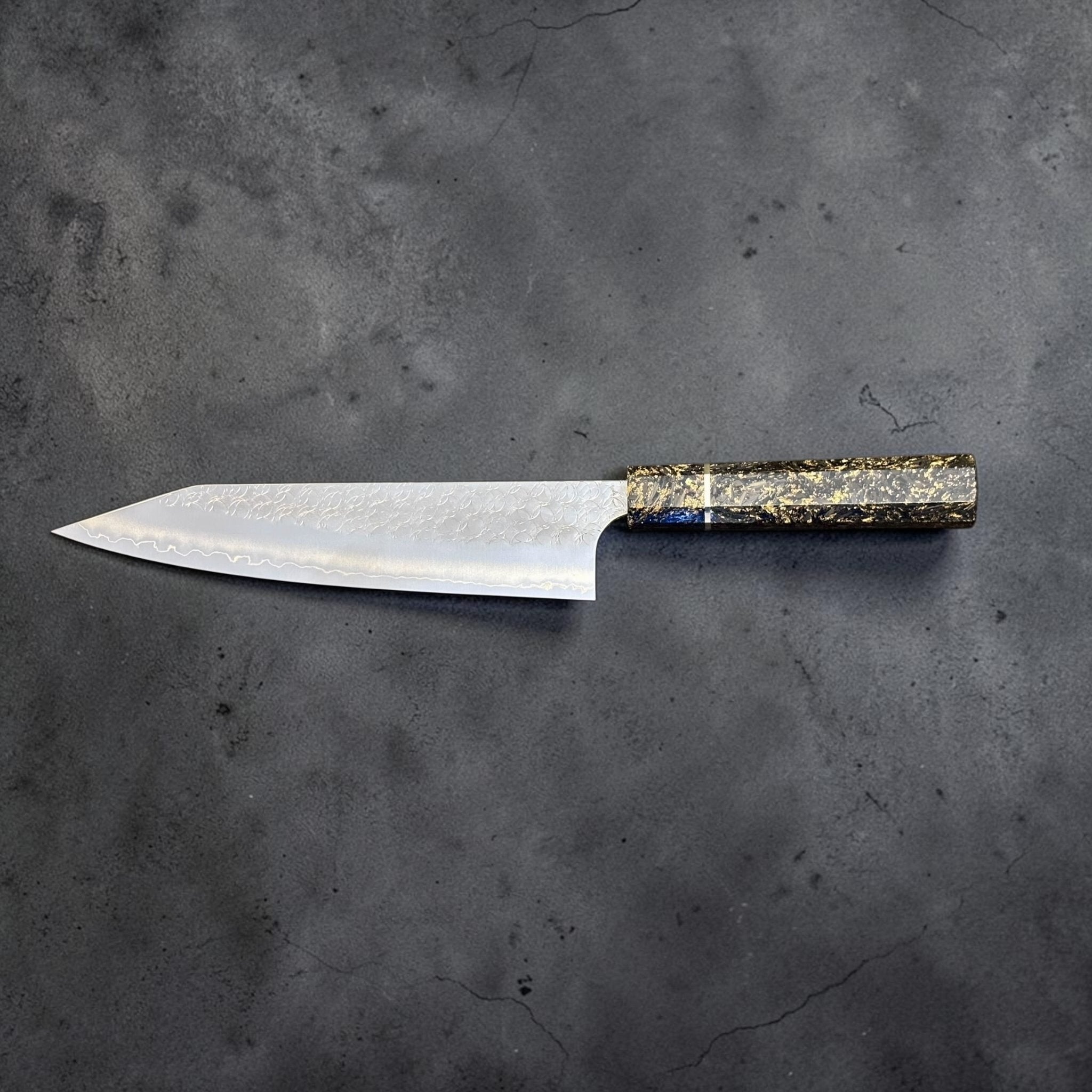 Yoshimi Kato Minamo SG2 Kiritsuke 210 mm with carbon fiber handle, reverse profile view on dark textured background.