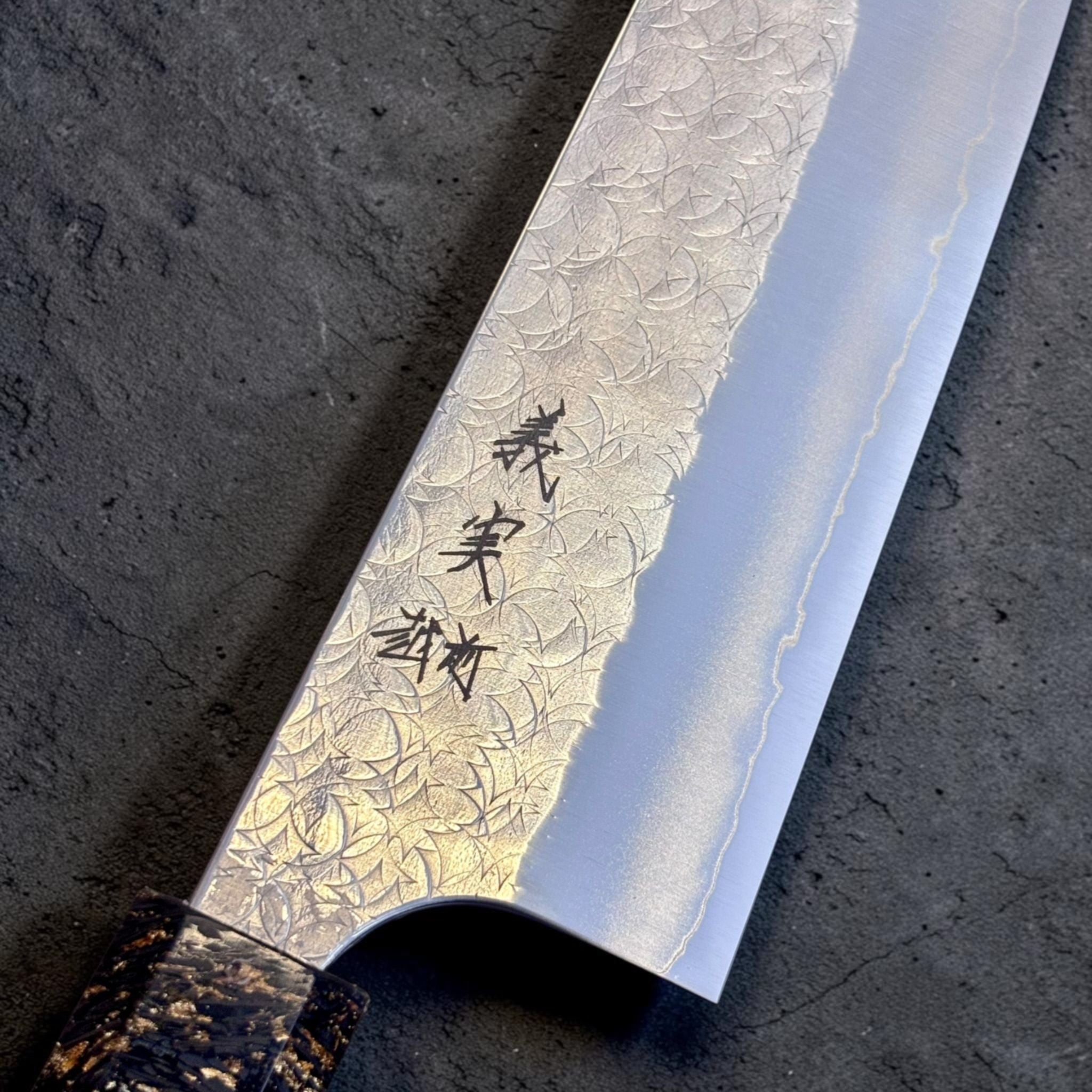 Yoshimi Kato Minamo SG2 Kiritsuke 210 mm, close-up of Minamo blade pattern and kanji detail.