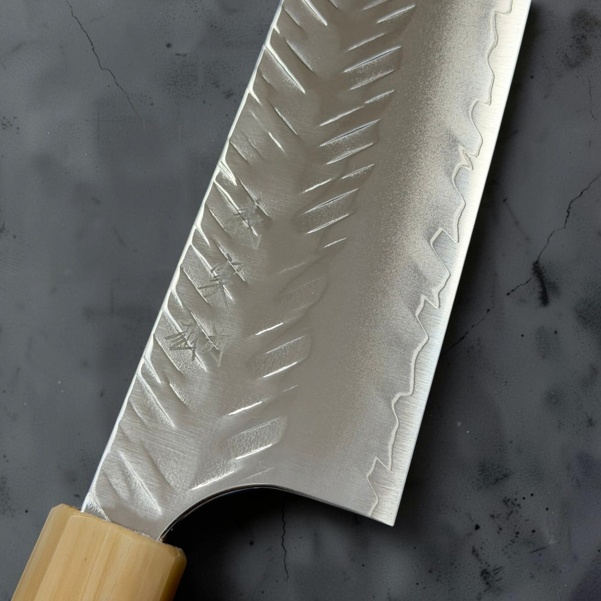 Close-up of Yoshimi Kato SG-STRIX Bunka kanji, V-Tsuchime hammering and blade finish