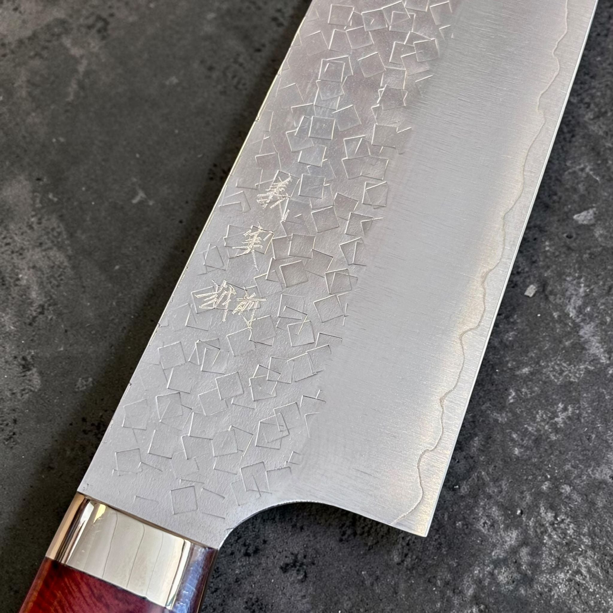Yoshimi Kato SG2 Kaku-Tsuchime Gyuto 210 mm, close-up of kaku-tsuchime hammer texture and kanji on the blade.