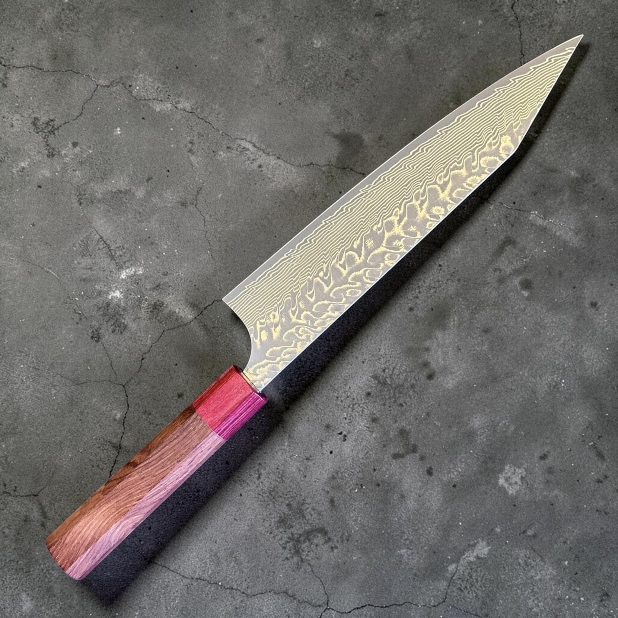 Yoshimi Kato SG2 Kuro Damascus Kiritsuke 210 mm with Honduran wood handle, angled full-profile view showing the Damascus blade pattern.
