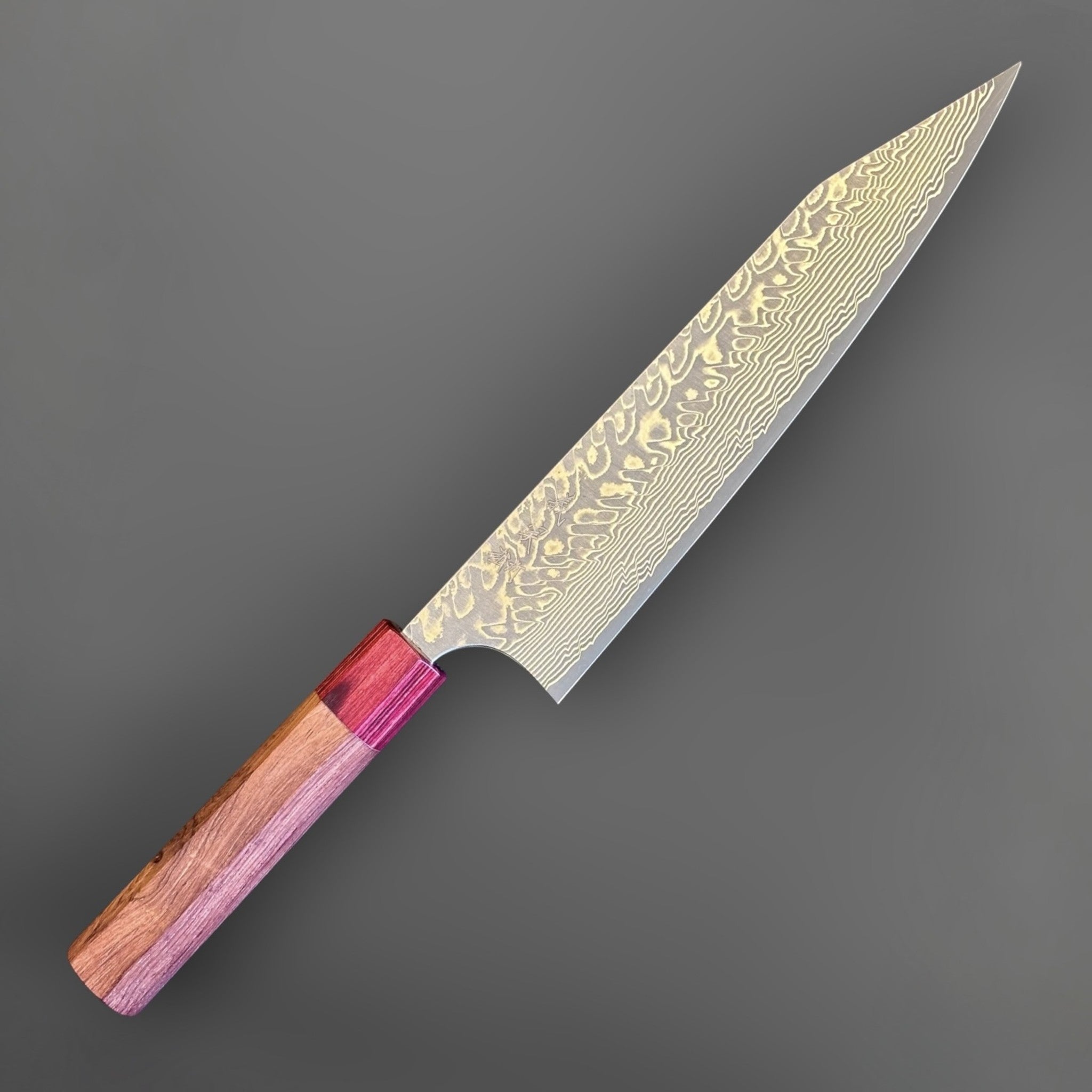 Yoshimi Kato SG2 Kuro Damascus Kiritsuke 210 mm with Honduran wood handle, close angled view of the kiritsuke tip and patterned blade face.