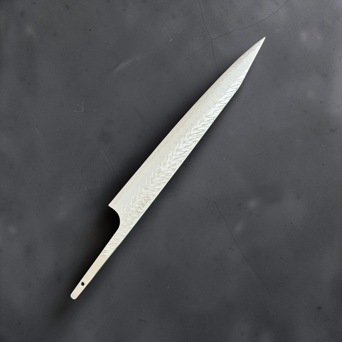 Reverse side of Yoshimi Kato SG-STRIX 270mm sujihiki blade without a handle, showing V-shaped hammer marks and pointed tip