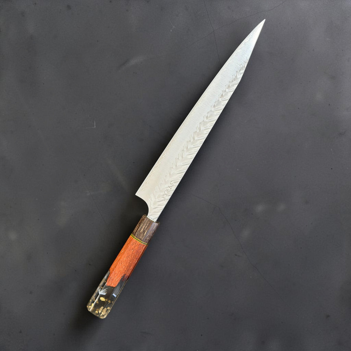 Reverse side of Yoshimi Kato SG-STRIX 270mm kiritsuke sujihiki with orange, black and gold-colored Prisma handle