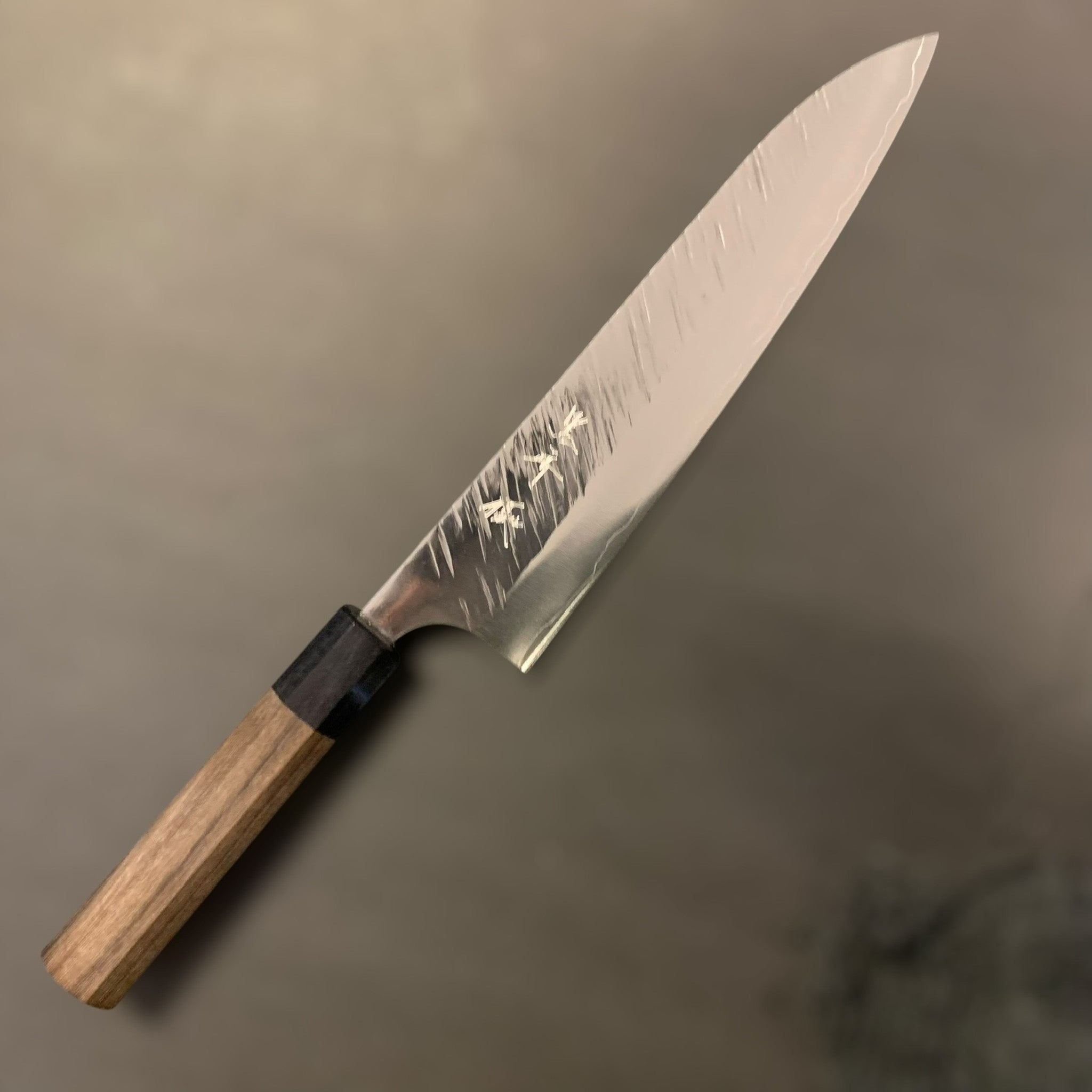 Yu Kurosaki Fujin SG2 Gyuto 210 mm, maker’s kanji and Fujin hammered pattern visible, full knife on a grey background.