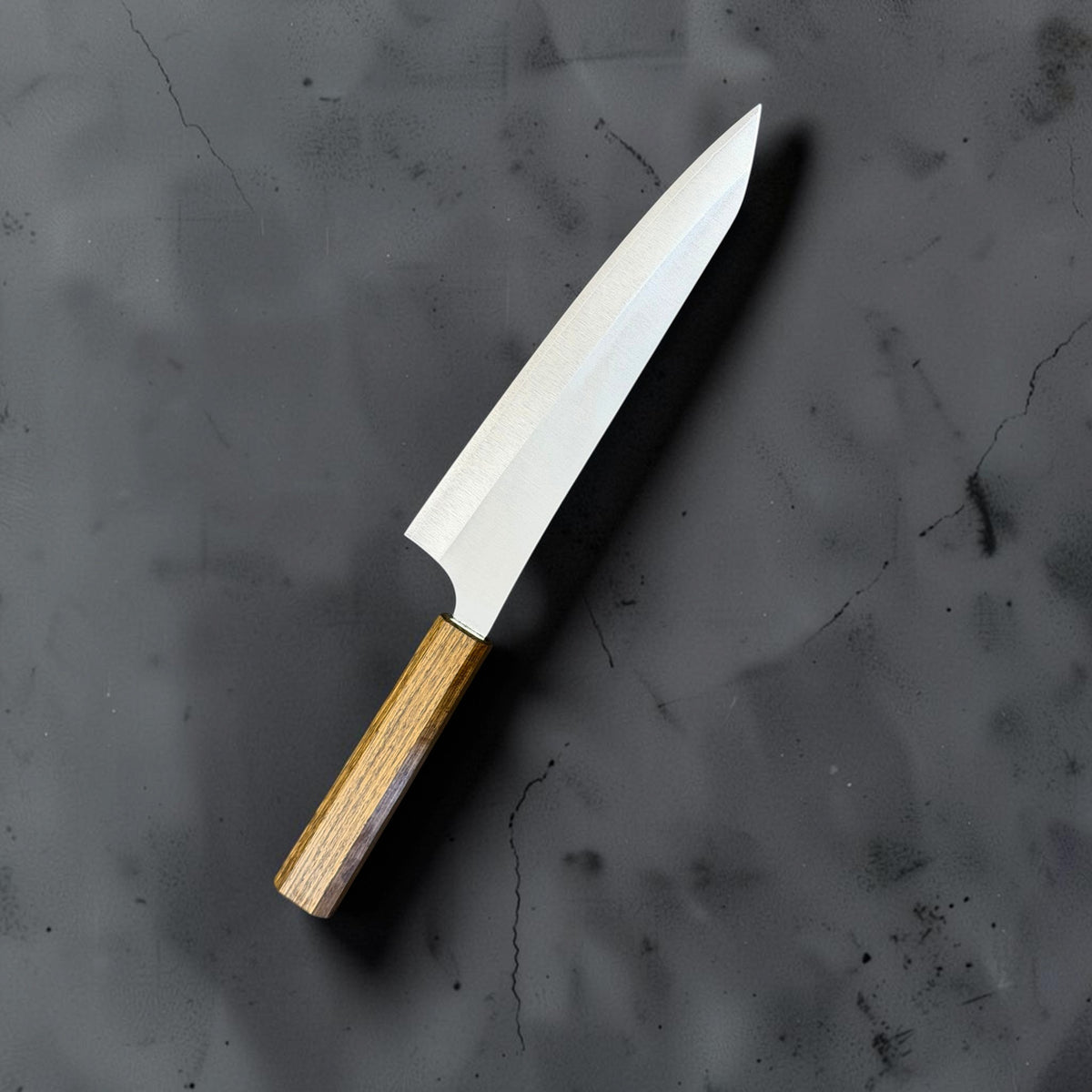 Reverse angled view of the Yu Kurosaki Gekko VG-XEOS 210mm gyuto with oak handle