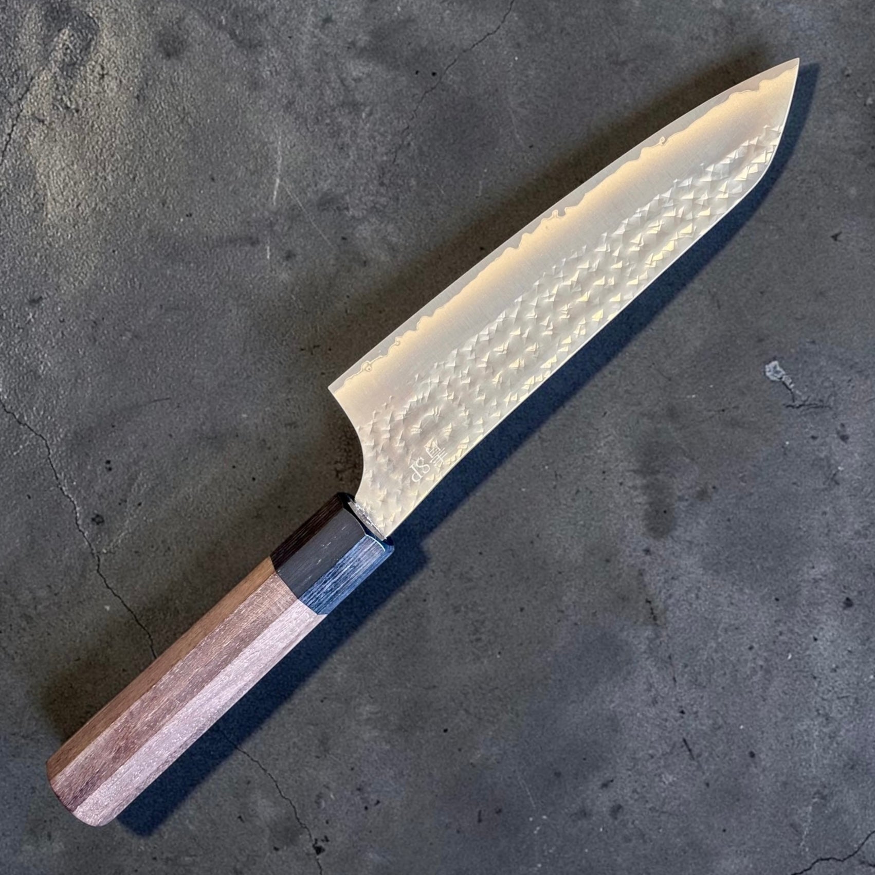 Angled view of the Yu Kurosaki Kokusen AS Bunka 165mm with rosewood octagon wa handle