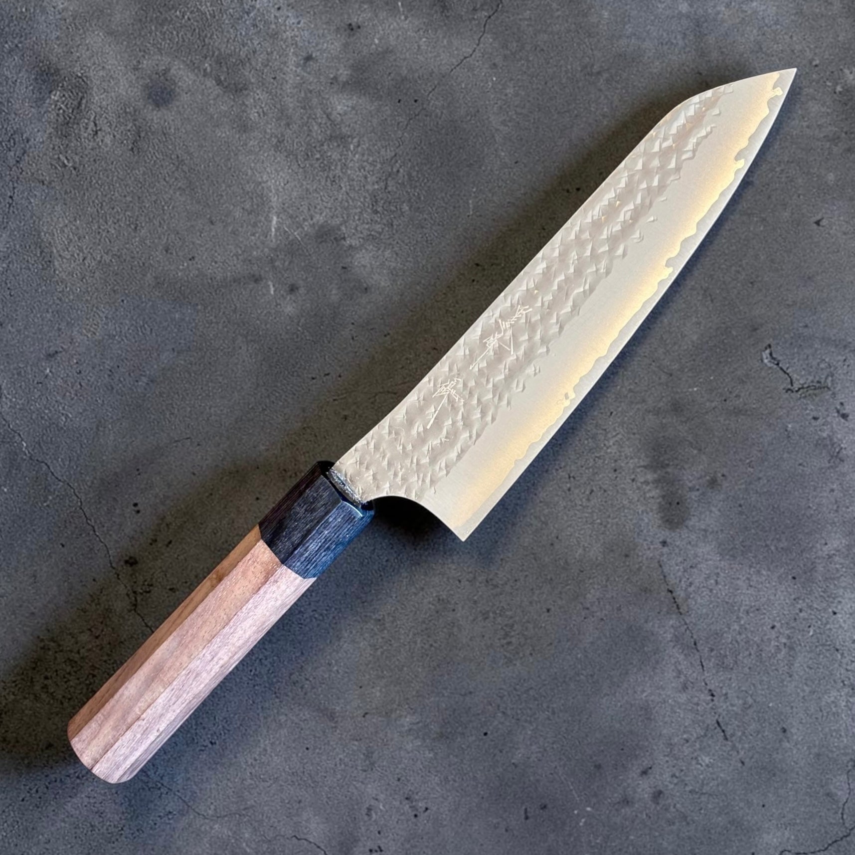 Yu Kurosaki Kokusen AS Bunka 165mm with rosewood octagon wa handle on a dark stone background