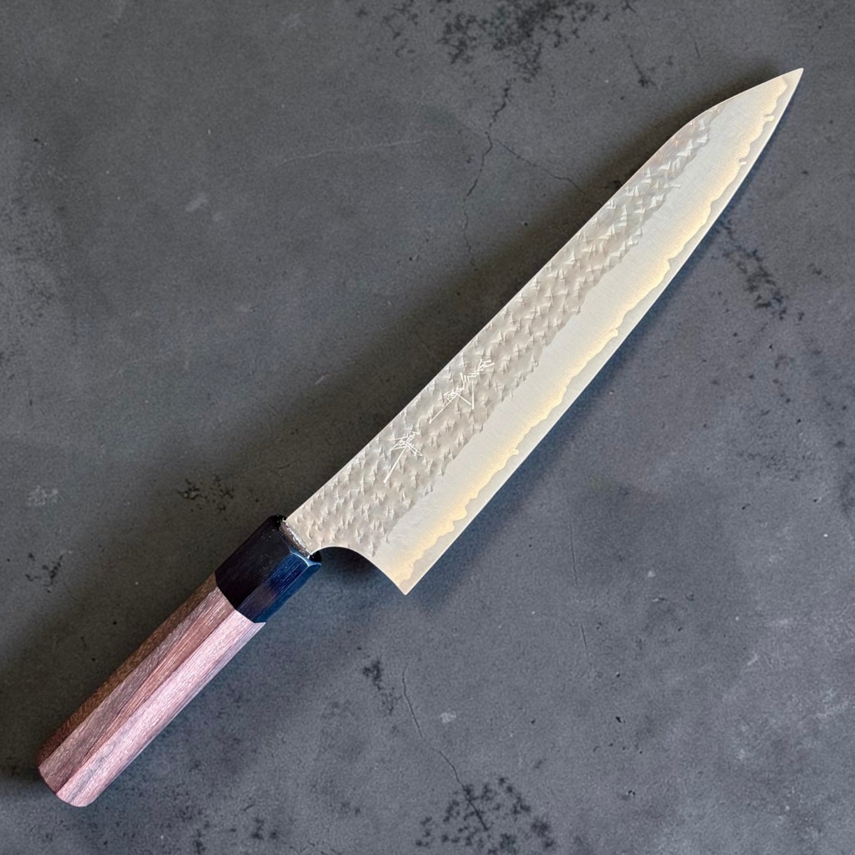 Angled view of the Yu Kurosaki Kokusen AS Gyuto 210mm with rosewood octagon wa handle