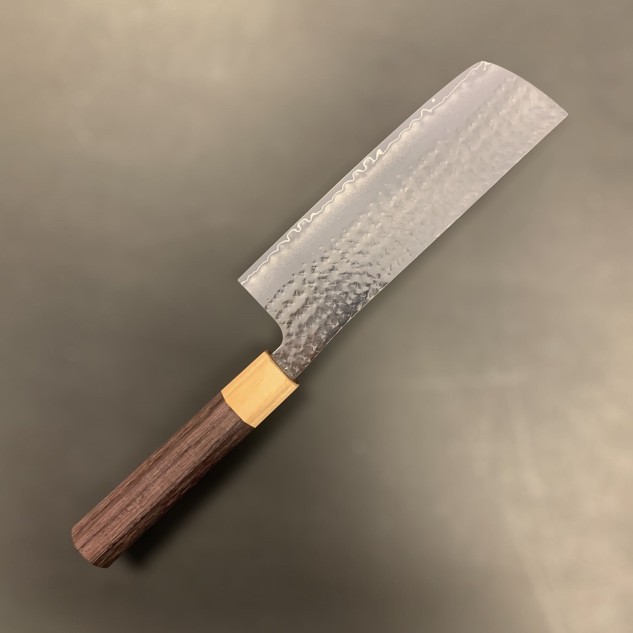 Yu Kurosaki Senko SG2 Ei Nakiri 165 mm, reverse side three-quarter view showing hammered tsuchime cladding, subtle hamon-like cladding line, and octagonal wa handle.