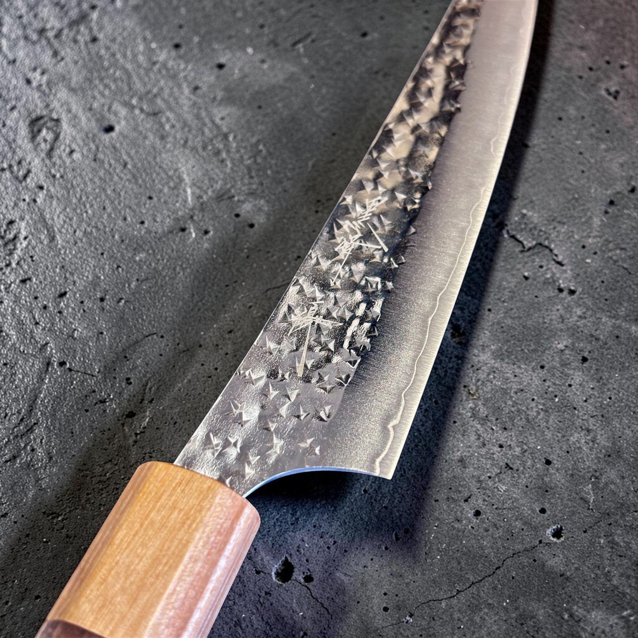 Yu Kurosaki Senko Ei SG2 Petty 150 mm, close-up of the hammered SG2 blade face and kanji detail near the handle.