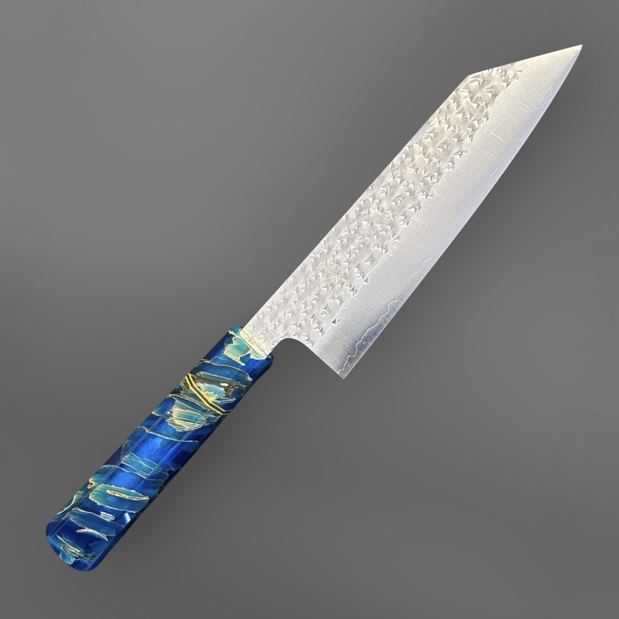 Yu Kurosaki Senko SG2 Bunka with Custom Blue Twistwood Prisma Knife Handle, alternate angled product photo highlighting the bunka tip profile, hammered blade texture, and custom blue Twistwood handle.
