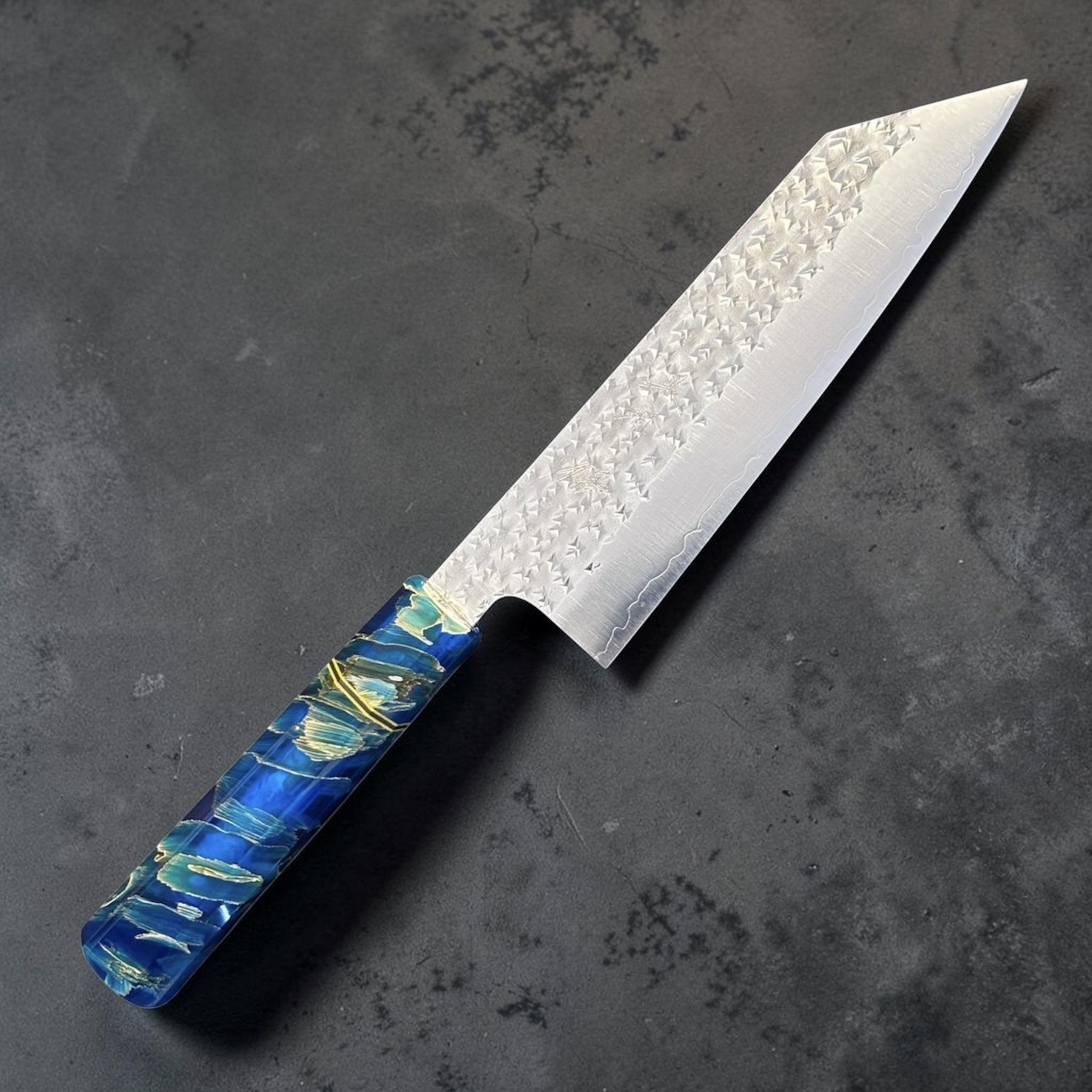 Yu Kurosaki Senko SG2 Bunka with Custom Blue Twistwood Prisma Knife Handle, alternate angled product photo highlighting the bunka tip profile, hammered blade texture, and custom blue Twistwood handle.