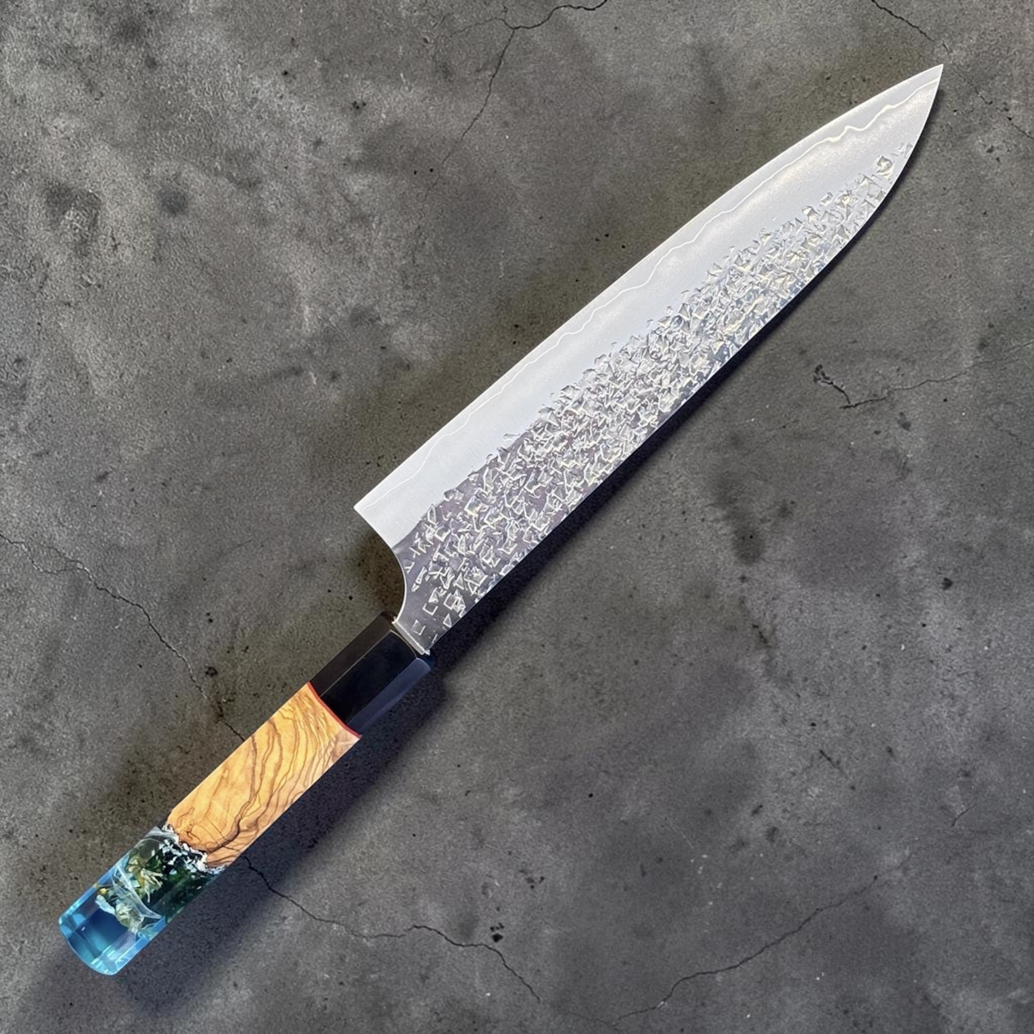 Yu Kurosaki Shizuku SG2 Gyuto 210 mm Custom with Prisma Knife Mountain Spring Handle, angled full-profile product photo showing the hammered Shizuku blade and custom Prisma Knife Mountain Spring handle.