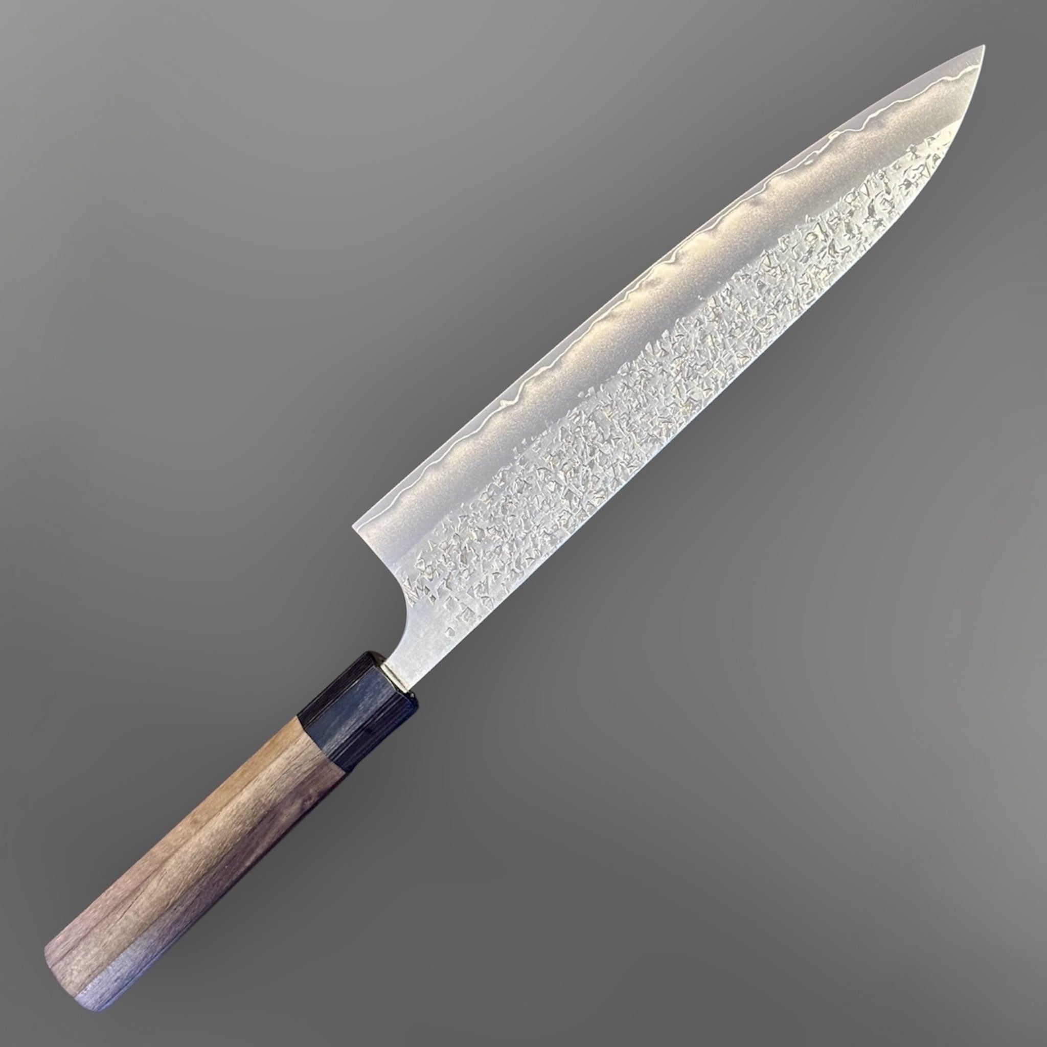 Yu Kurosaki Shizuku SG2 Gyuto 240 mm, angled product view highlighting the Shizuku hammered finish and pointed gyuto profile.