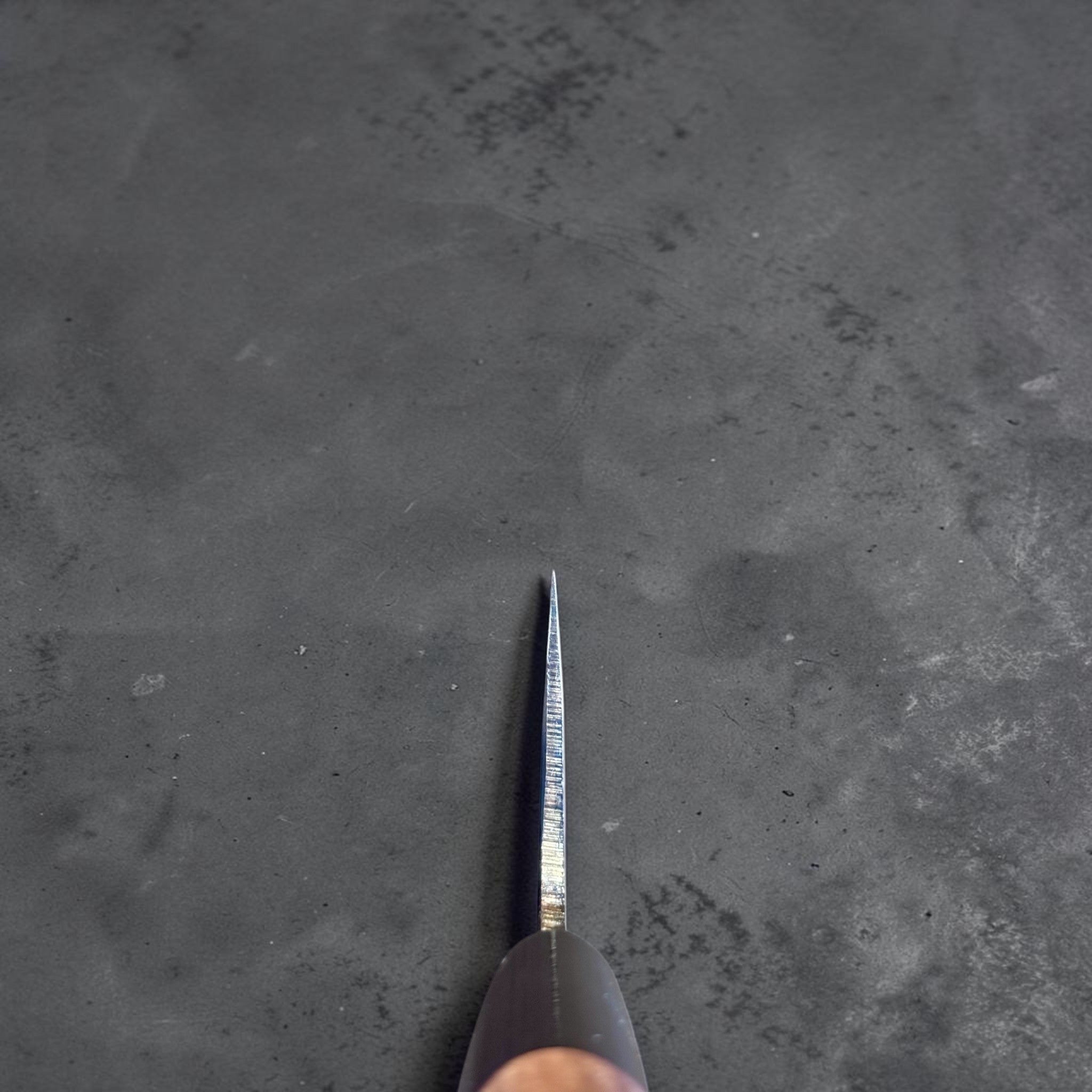 Zakuri AS Kurouchi Bunka 165 mm with kurouchi finish and wa handle, choil view showing spine and edge geometry.