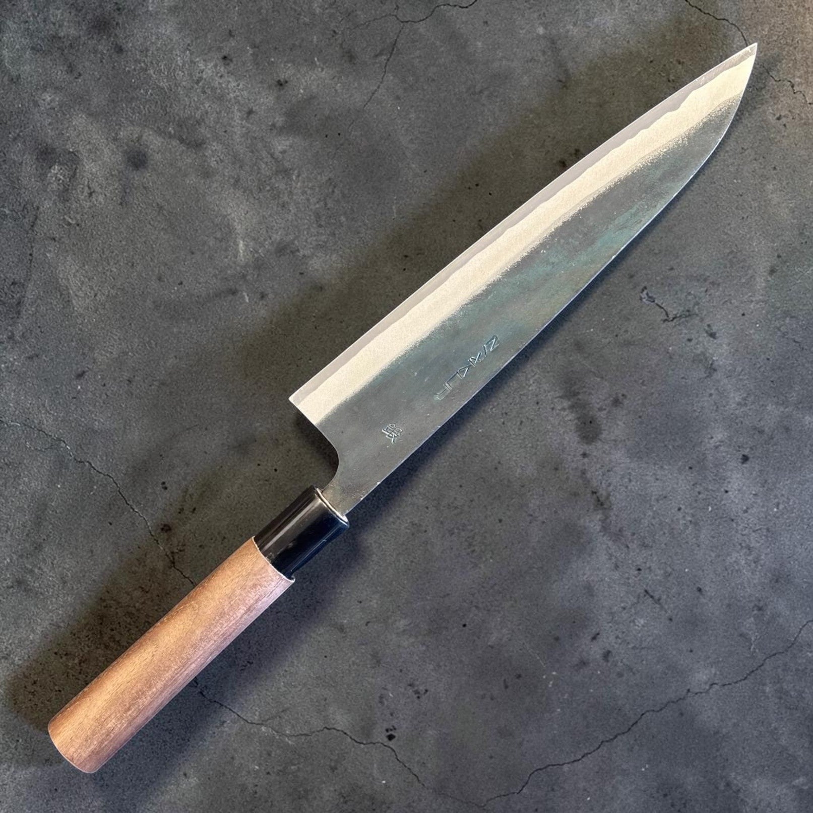 Zakuri AS Kurouchi Gyuto 210 mm, alternate side profile showing the kurouchi finish, bright bevel, and wa handle.