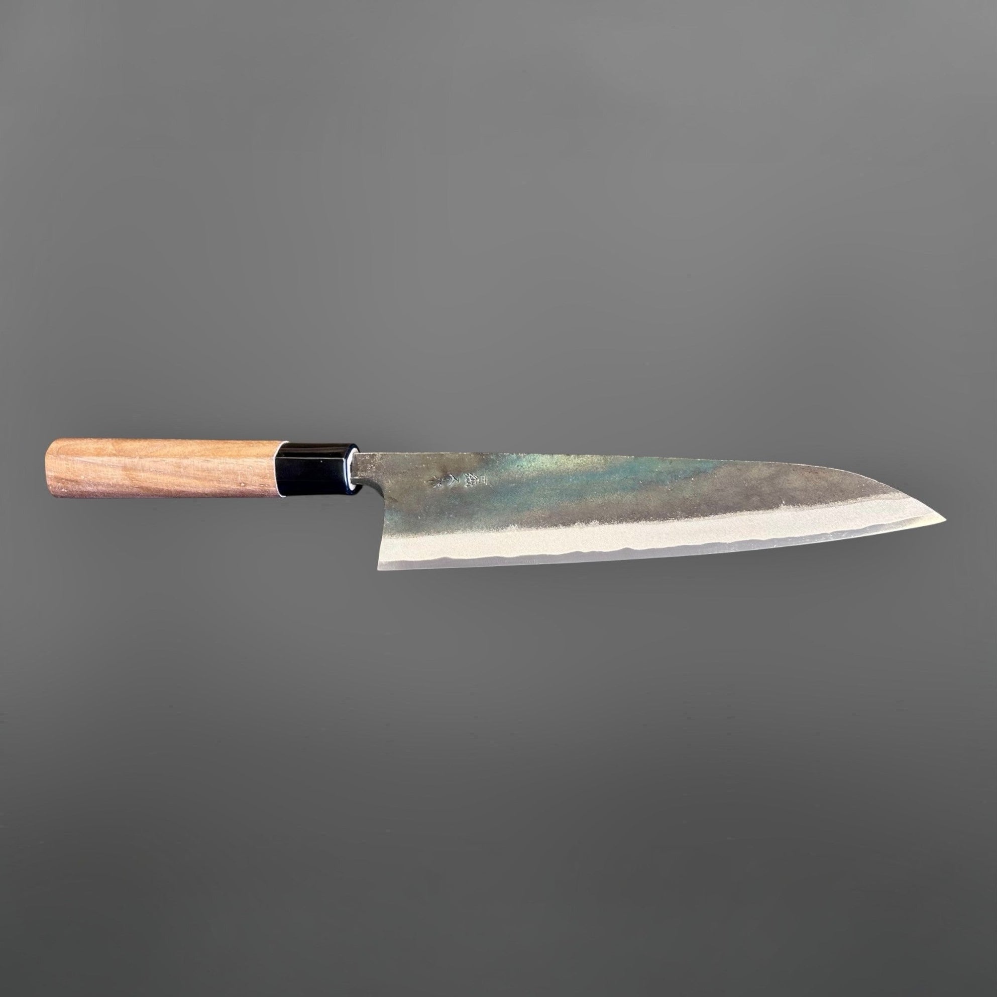 Zakuri AS Kurouchi Gyuto 210 mm, horizontal full-knife profile showing the blade geometry and handle alignment.