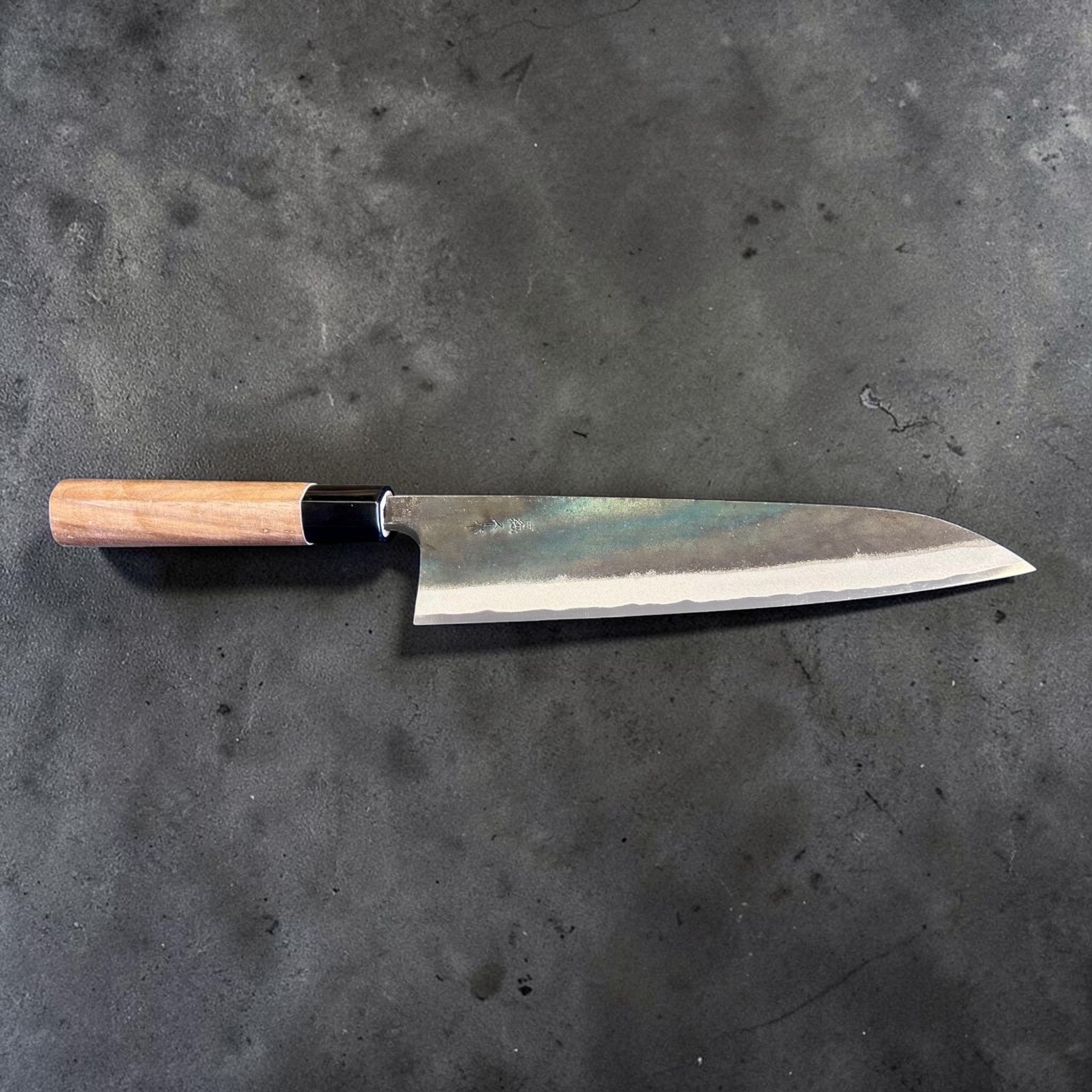 Zakuri AS Kurouchi Gyuto 210 mm, horizontal full-knife profile showing the blade geometry and handle alignment.