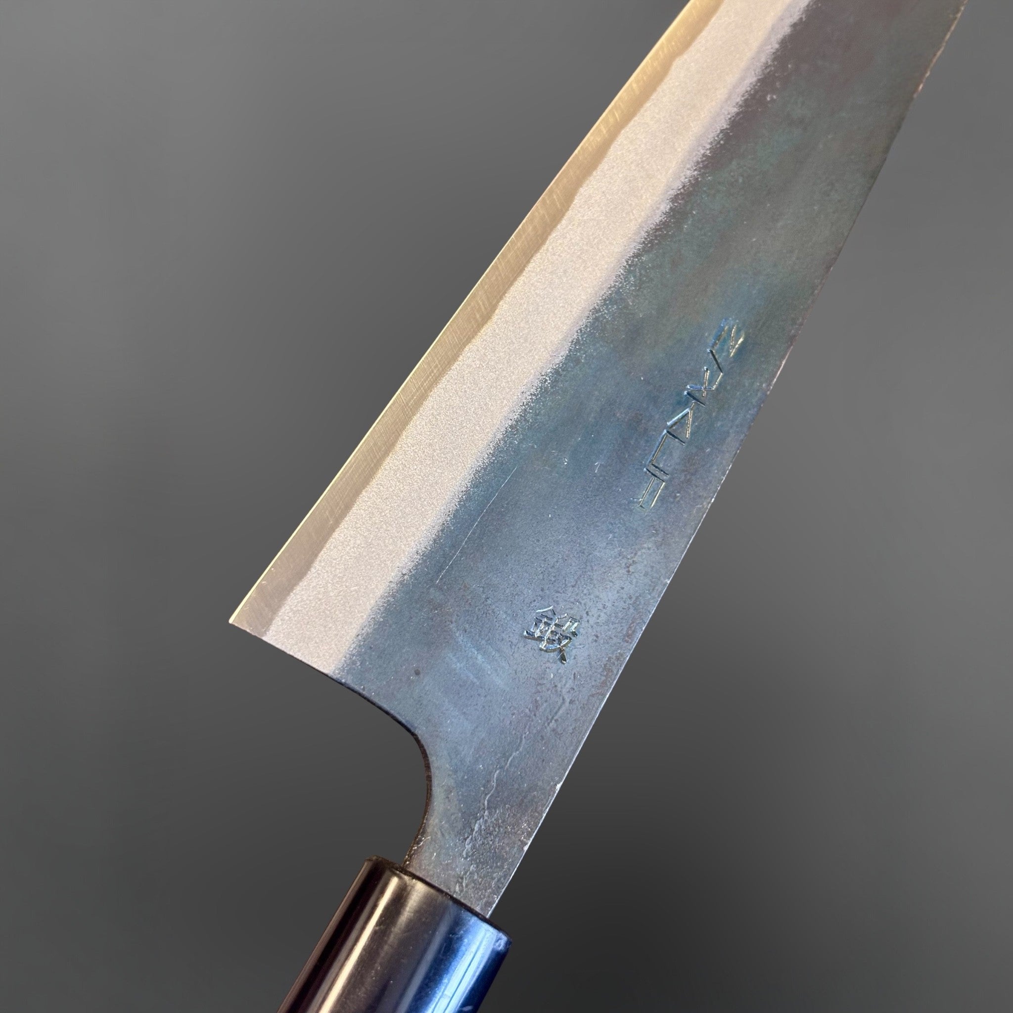 Zakuri AS Kurouchi Gyuto 210 mm, close-up of the blade face, kanji, kurouchi finish, and polished bevel.