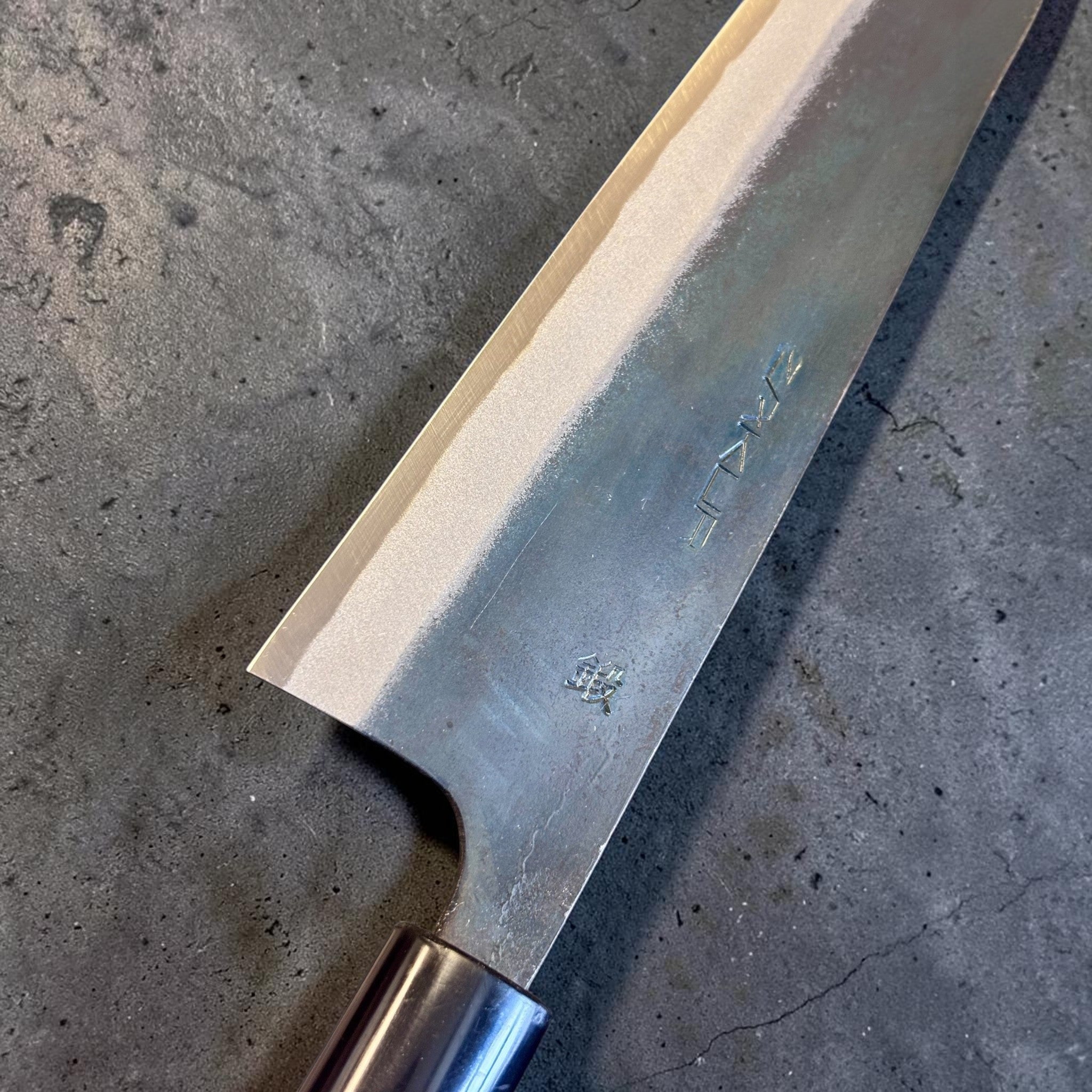 Zakuri AS Kurouchi Gyuto 210 mm, close-up of the blade face, kanji, kurouchi finish, and polished bevel.