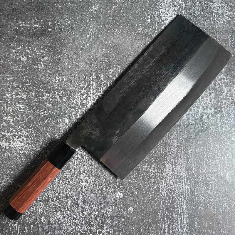 Angled view of FOOK KEE Model #1 Chinese Cleaver showcasing the blade and Wa handle on concrete