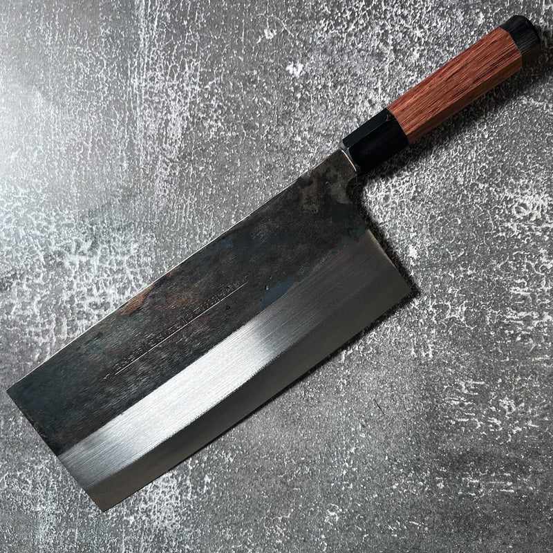 FOOK KEE Model #1 Chinese Cleaver with exclusive Wa handle on a textured concrete background