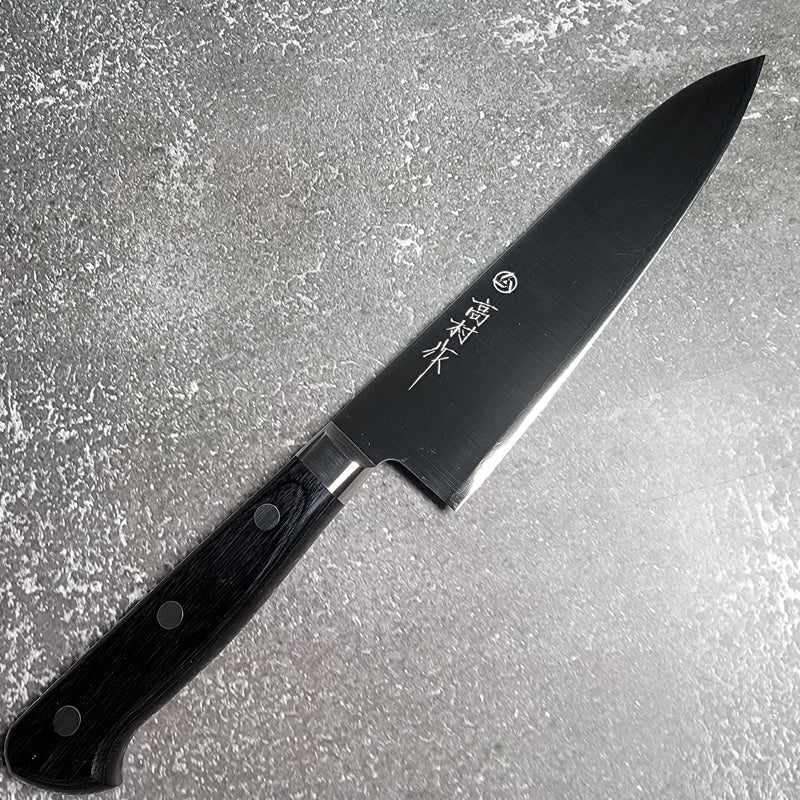 Profile view of the Takamura VG-10 Migaki Gyuto 180mm chef's knife with a sleek black handle